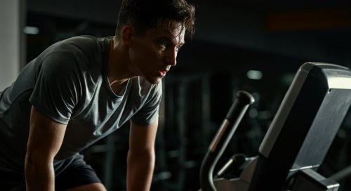 Athletische Person nach einem intensiven HIIT auf dem Stairmaster, die erschöpft, aber zufrieden ist. Athletische Person nach einem intensiven HIIT auf dem Stairmaster, die erschöpft, aber zufrieden ist.