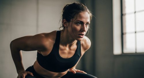 Eine Frau führt einen intensiven Squat Jump während ihres HIIT-Workouts für die Beine aus. Eine Frau führt einen intensiven Squat Jump während ihres HIIT-Workouts für die Beine aus.